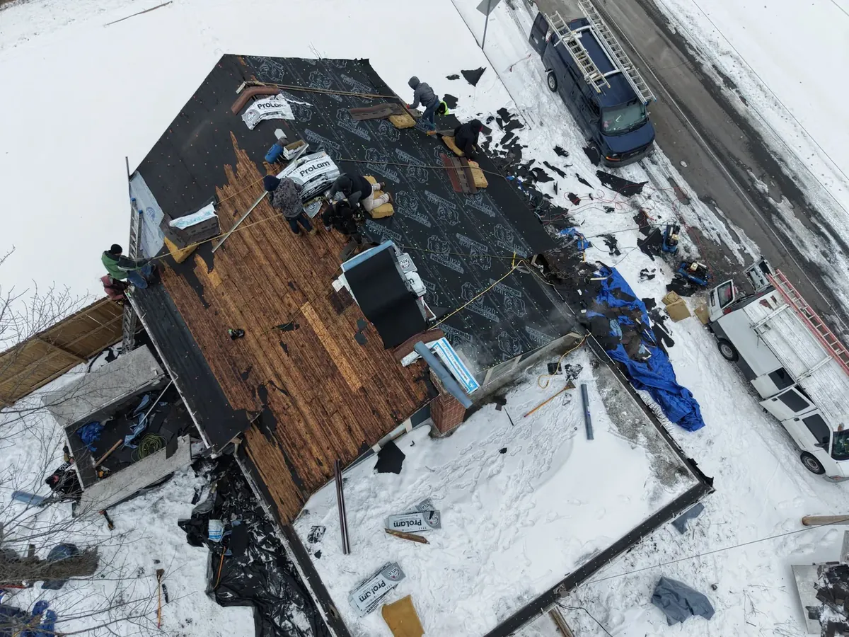 GNG Roofing crew installing a new roof in winter